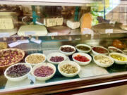 The deli cases at La Bottega in Vancouver offer a variety of olives, cheeses and meats.
