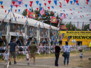 Shoppers visit TNT Fireworks, left, and the nearby Blackjack Fireworks while preparing for their Fourth of July celebrations Friday morning. Fireworks business owners expect crowds to grow larger and larger over the weekend; they'll also be open on Monday.