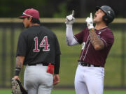 Raptors first baseman Safea Mauai, right, points and celebrates after a hit Wednesday, July 6, 2022, during a game between the Ridgefield Raptors and the Corvallis Knights at the Ridgefield Outdoor Recreation Complex.