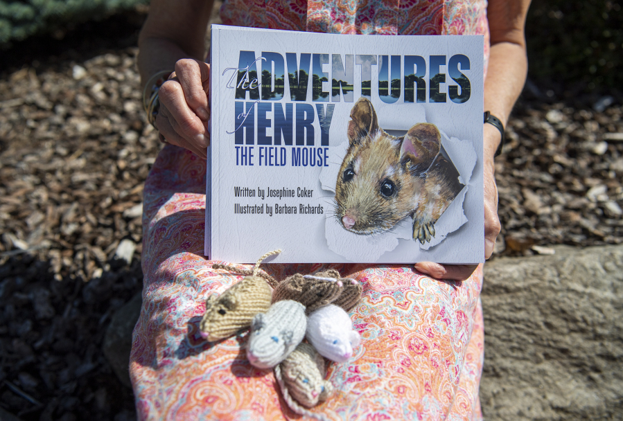 Sue Dockstader holds "The Adventures of Henry the Field Mouse," written by her English mother, Jo Coker, along with Coker's hand-knitted mice. The stories are compiled from letters that Coker wrote to Dockstader's children 20 years ago.