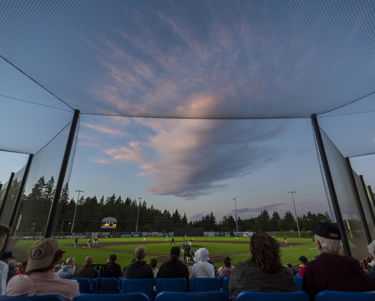 The sunset illuminates a cloud over the Ridgefield Outdoor Recreation Complex on Tuesday, July 12, 2022, during a game between the Ridgefield Raptors and the Bellingham Bells.