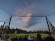 The sunset illuminates a cloud over the Ridgefield Outdoor Recreation Complex on Tuesday, July 12, 2022, during a game between the Ridgefield Raptors and the Bellingham Bells.