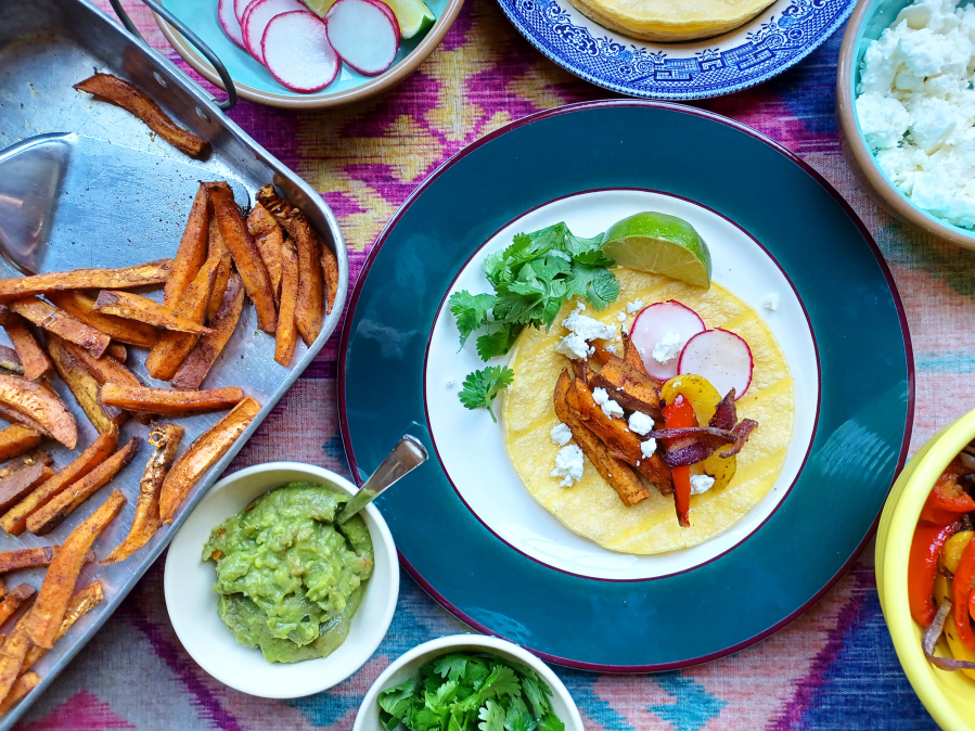 These sweet potato fajitas rely on the sweetness of roasted vegetables for big flavor. Serve them with traditional street taco fixings, like cotija cheese, lime wedges, guacamole and radish slices.