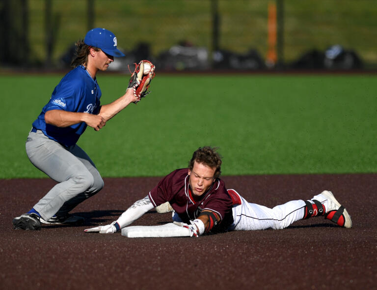 Raptors shortstop Travis Welker, right, slides safely into second base Friday, July 15, during a game between the Raptors and the Springfield Drifters at the Ridgefield Outdoor Recreation Center.