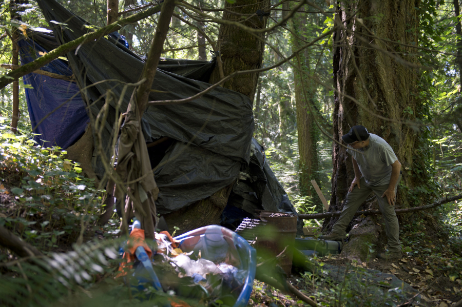 Peter Bracchi, who has advocated for a camping ban for years, walks through an abandoned homeless encampment in Vancouver's Arnold Park. The Vancouver City Council approved amendments Monday to its camping ordinance that address fire impact zones surrounding Burnt Bridge Creek. City staff said the area's dense vegetation, steep hills and limited sources of water make it susceptible to wildfires. Homeless encampments nestled in the area pose an increased danger, as fires for cooking or warmth could easily spread and wouldn't be accessible to firefighters.
