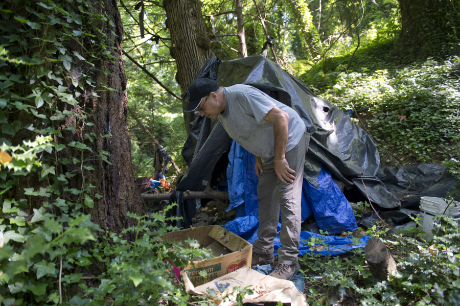 Peter Bracchi, who has advocated for a camping ban for years, walks through an abandoned homeless encampment in Vancouver's Arnold Park. The Vancouver City Council approved amendments Monday to its camping ordinance.