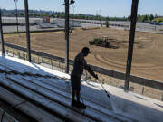 Carlos Da Silva of ABC Janitorial Services pressure-washes the bleachers in the grandstand. The fair offers free shows daily including concerts, rodeo and motor sports.
