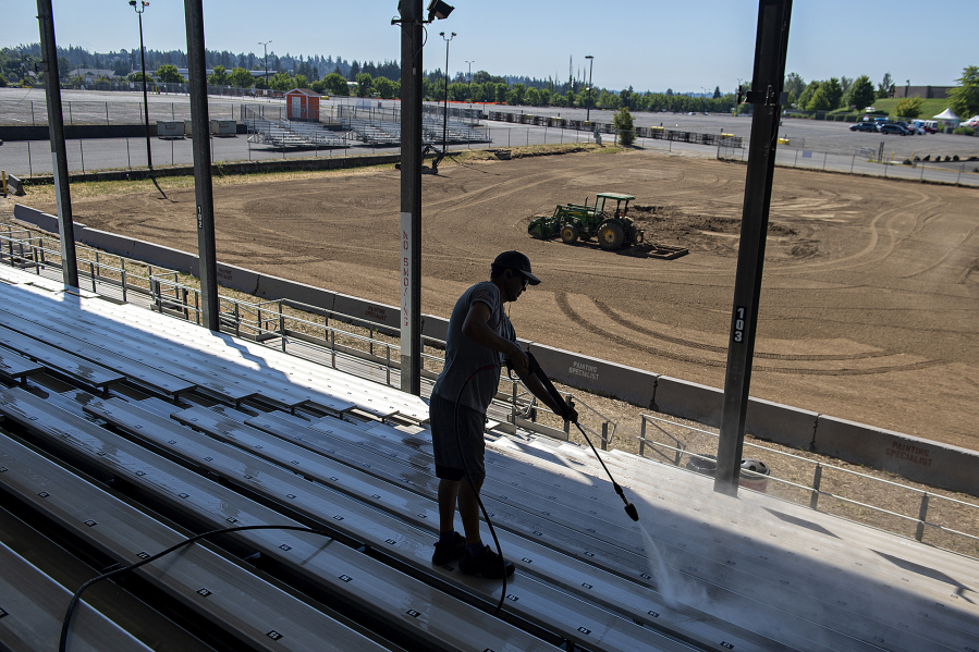 Carlos Da Silva of ABC Janitorial Services pressure-washes the bleachers in the grandstand. The fair offers free shows daily including concerts, rodeo and motor sports.