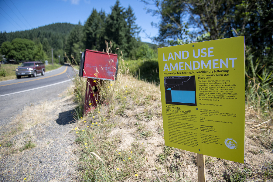 A motorist traveling on Northeast Healy Road passes a sign notifying neighbors about renewed Clark County procedures that could eventually lead to gravel mining.