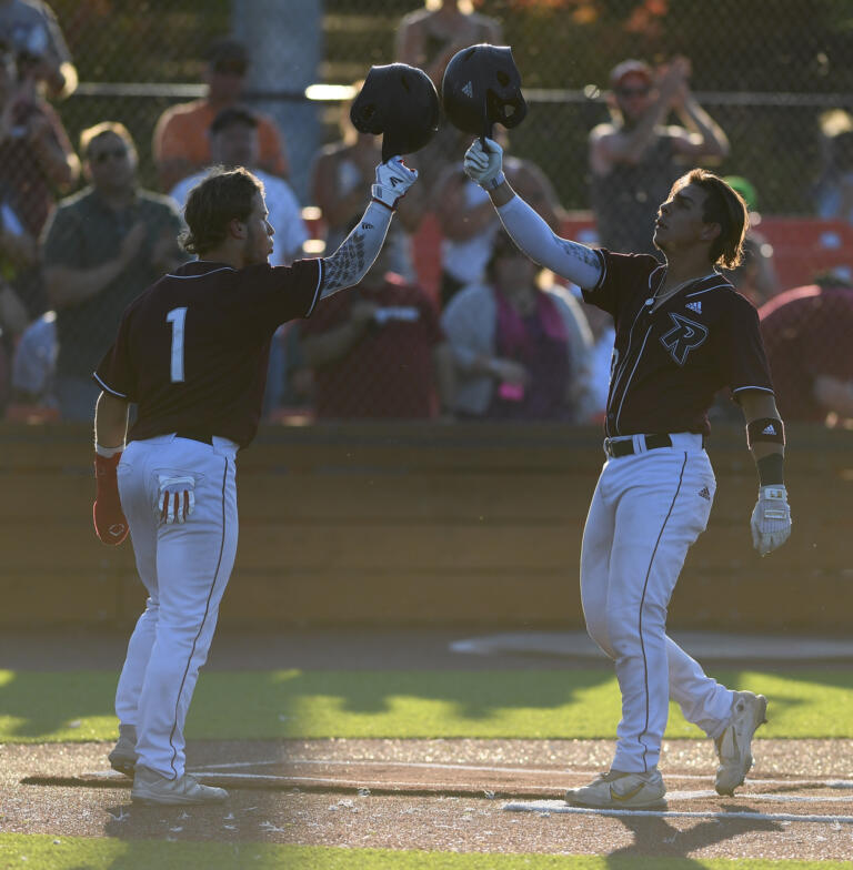 Raptors catcher Jacob Sharp, right, celebrates with shortstop Travis Welker on Tuesday, July 26, 2022, after Sharp hit a home run in a game between Ridgefield and the Bend Elks at the Ridgefield Outdoor Recreation Complex.