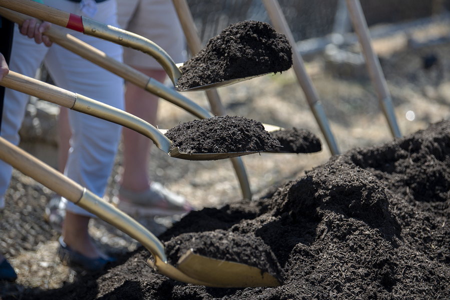 The ceremony was held inside Open House Ministries' multi-purpose gym due to the heat. After speakers concluded, however, donors and Open House Ministries' leadership carried shovels over to the empty plot to break the ground.