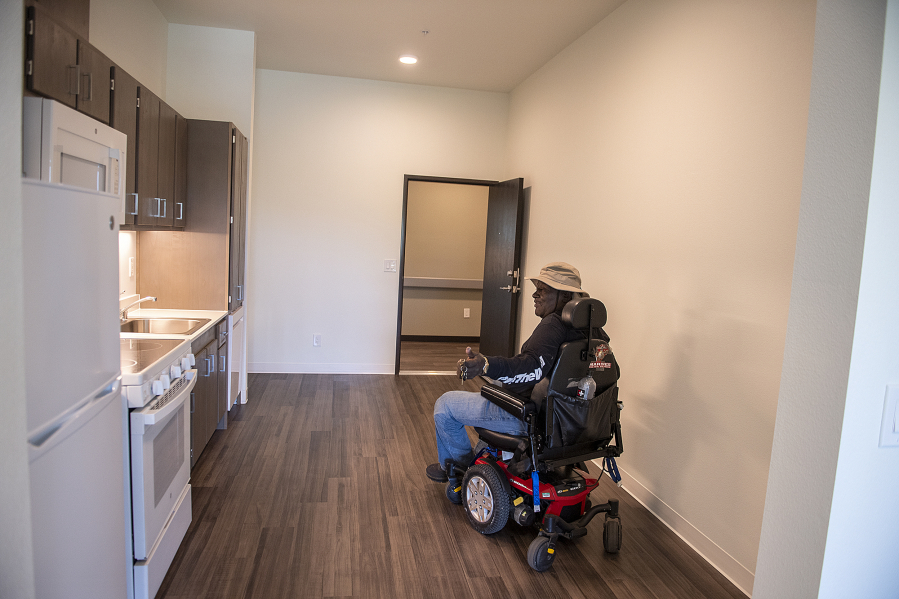 Future resident Deone Washington tours a one-bedroom unit during the grand opening ceremony for Miles Terrace, a new 69-unit affordable housing complex for low-income seniors in downtown Vancouver, on Friday afternoon. "This is going to be a blessing for me," he said.