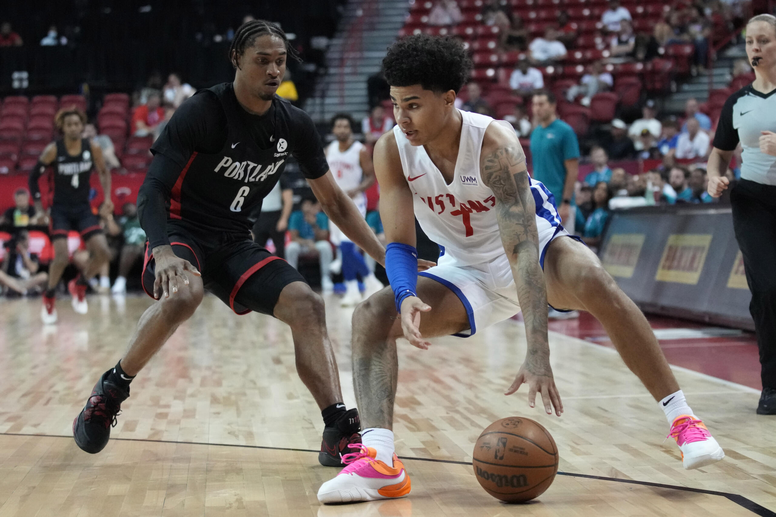Detroit Pistons' Killian Hayes, right, and Portland Trail Blazers' Keon Johnson vie for the ball during the second half an NBA summer league basketball game Thursday, July 7, 2022, in Las Vegas.