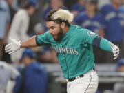 Seattle Mariners' Eugenio Suarez reacts after he hit a walk-off three-run home run against the Toronto Blue Jays during the 11th inning of a baseball game, Friday, July 8, 2022, in Seattle. The Mariners won 5-2 in 11 innings. (AP Photo/Ted S.