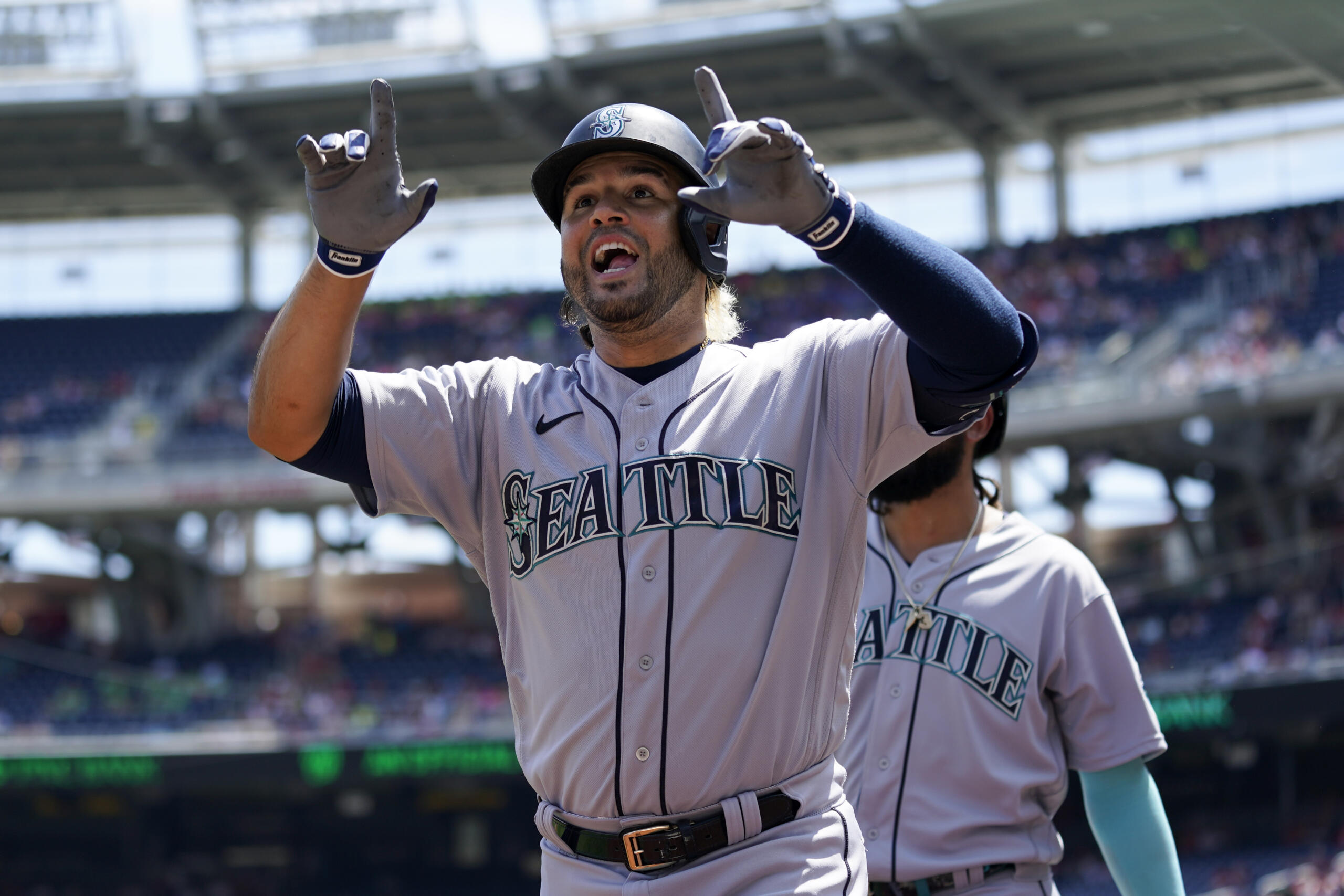 Seattle Mariners' Eugenio Suarez reacts after hitting a three-run home run in the first inning of the first game of a baseball doubleheader against the Washington Nationals, Wednesday, July 13, 2022, in Washington.