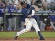 Seattle Mariners' Ty France hits a solo home run against the Texas Rangers during the fifth inning of a baseball game, Monday, July 25, 2022, in Seattle. (AP Photo/Ted S.