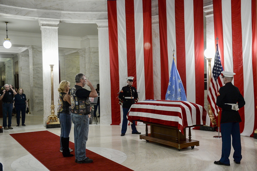 People salute the casket of Hershel "Woody" Williams set up in the first floor rotunda of the West Virginia State Capitol in Charleston, W.Va., for visitation on Saturday, July 2, 2022. Williams, 98, a West Virginian who was the last living Medal of Honor recipient from World War II, died on Wednesday, June 29. His funeral is set for Sunday, July 3.