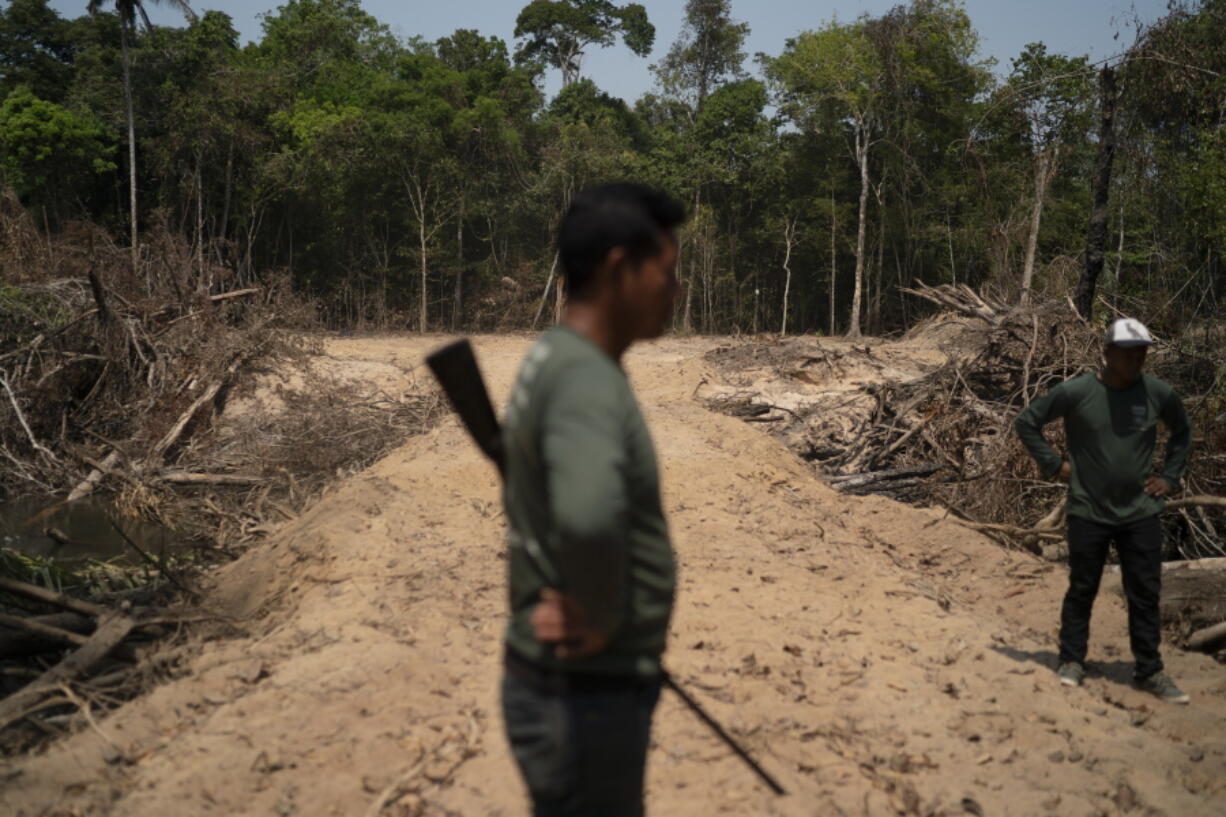 FILE - Monhire Menkragnotire, of the Kayapo indigenous community, center, surveys an area where illegal loggers opened a road to enter Menkragnotire indigenous lands, on the border with the Biological Reserve Serra do Cachimbo, top, where logging is also illegal, in Altamira, Para state, Brazil on Aug. 31, 2019. Environmental criminals in the Brazilian Amazon destroyed public forests equal the size of El Salvador over the past six years, yet the Federal Police carried out only seven operations aimed at this massive loss, according to a new study released Wednesday, July 20, 2022.