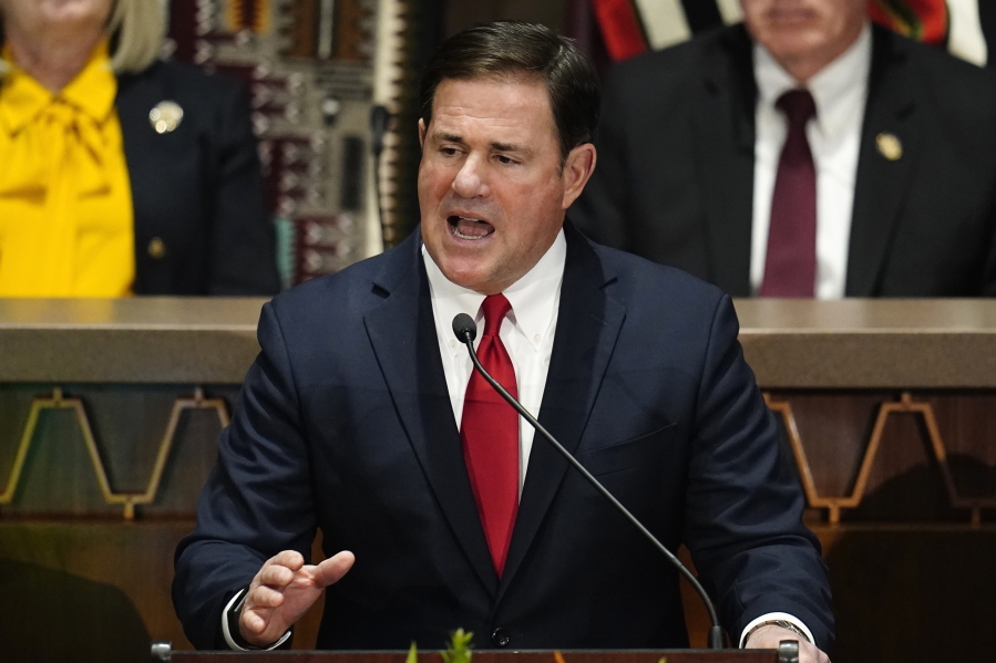 FILE - Arizona Republican Gov. Doug Ducey gives his state of the state address at the Arizona Capitol, Monday, Jan. 10, 2022, in Phoenix. The U.S. Department of Justice is suing Arizona over a new law requiring people who use a federal form to register to vote to provide additional proof of citizenship if they want to vote for president. The lawsuit filed on Tuesday, July 5  says the law signed by Ducey in March is in direct conflict with a 1993 federal voter registration law and also violates the Civil Rights Act of 1964. (AP Photo/Ross D.
