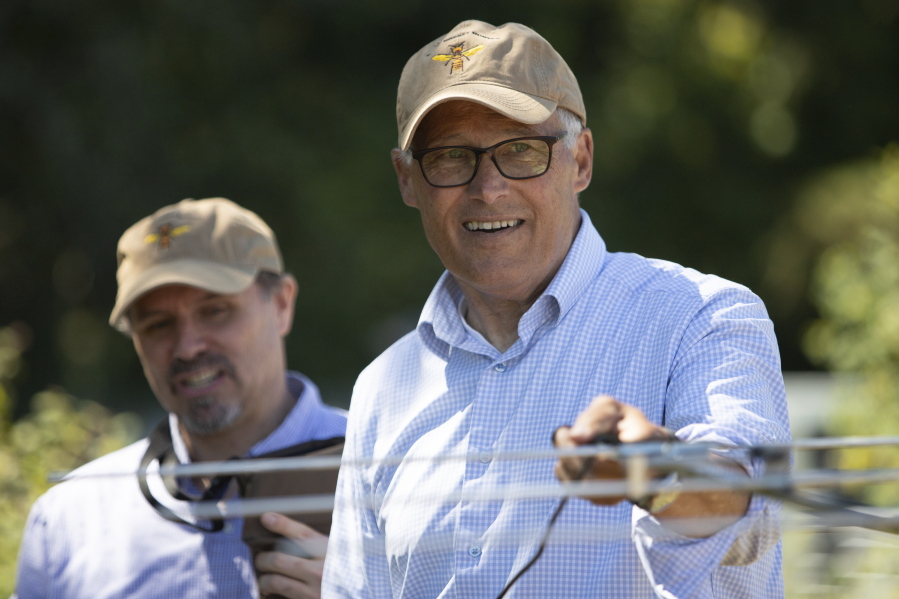 Gov. Jay Inslee waves an antenna to locate a tracker used for tracing Asian giant hornets in Blaine, Wash., Tuesday, July 12, 2022. The Washington State Department of Agriculture hosted a tracking and trapping training session at Birch Bay State Park in Blaine.