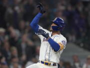 Seattle Mariners' Julio Rodriguez gestures after crossing the plate after he hit a solo home run against the Oakland Athletics during the first inning of a baseball game, Sunday, July 3, 2022, in Seattle. (AP Photo/Ted S.