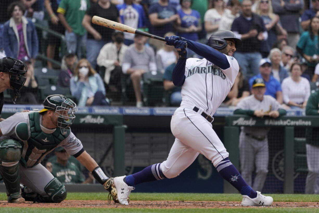 Seattle Mariners' Abraham Toro hits a single to score Marcus Wilson with the winning run during the ninth inning of the team's baseball game against the Oakland Athletics, Saturday, July 2, 2022, in Seattle. The Mariners won 2-1. (AP Photo/Ted S.