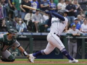 Seattle Mariners' Abraham Toro hits a single to score Marcus Wilson with the winning run during the ninth inning of the team's baseball game against the Oakland Athletics, Saturday, July 2, 2022, in Seattle. The Mariners won 2-1. (AP Photo/Ted S.