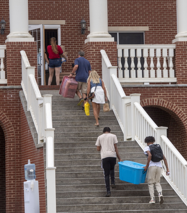 Incoming students, parents and volunteers move items into the dorms at Emory & Henry College, Aug. 12, 2021, in Emory, Va. It's dorm shopping season for parents sending their kids off to college.