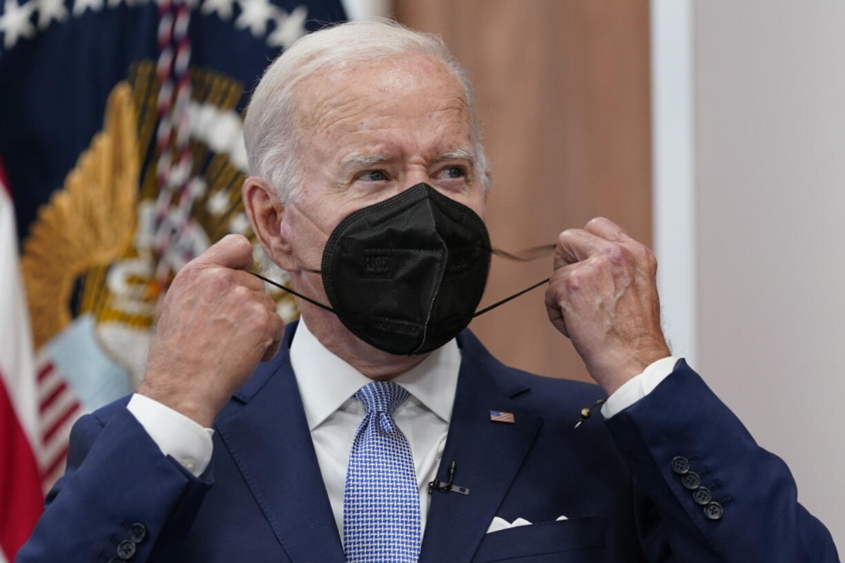 FILE - President Joe Biden removes his face mask as he arrives to speak about the economy during a meeting with CEOs in the South Court Auditorium on the White House complex in Washington, Thursday, July 28, 2022. Biden tested positive for COVID-19 again Saturday, July 30, slightly more than three days after he was cleared to exit coronavirus isolation, the White House said, in a rare case of "rebound" following treatment with an anti-viral drug.