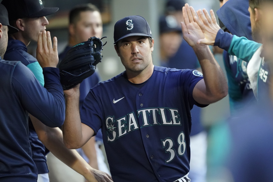 Seattle Mariners starting pitcher Robbie Ray is greeted in the dugout after getting out of a based-loaded jam in the fifth inning of the team's baseball game against the Toronto Blue Jays, Saturday, July 9, 2022, in Seattle. (AP Photo/Ted S.
