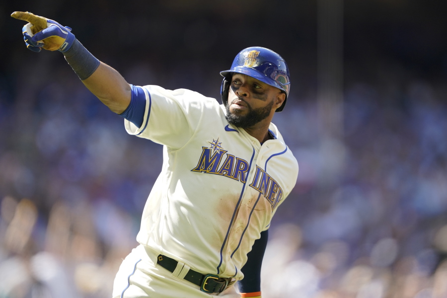 Seattle Mariners' Carlos Santana gestures as he heads to first after hitting a two-run home run against the Toronto Blue Jays during the eighth inning of a baseball game, Sunday, July 10, 2022, in Seattle. Santana had two home runs and the Mariners won 6-5. (AP Photo/Ted S.