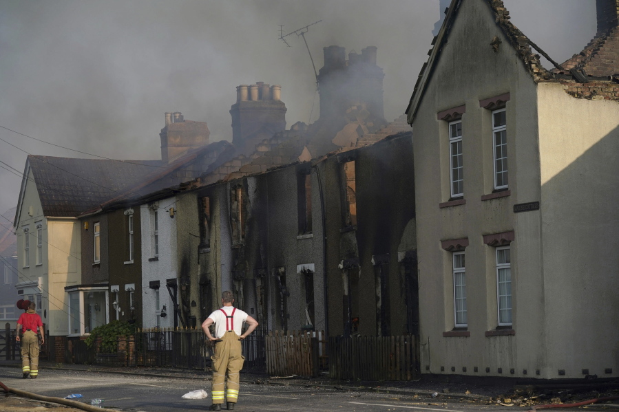The scene of a blaze in the village of Wennington, east London, Tuesday, July 19, 2022. The typically temperate nation of England is the latest to be walloped by unusually hot, dry weather that has triggered wildfires from Portugal to the Balkans and led to hundreds of heat-related deaths.