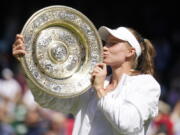 Kazakhstan's Elena Rybakina kisses the trophy as she celebrates after beating Tunisia's Ons Jabeur to win the final of the women's singles on day thirteen of the Wimbledon tennis championships in London, Saturday, July 9, 2022.