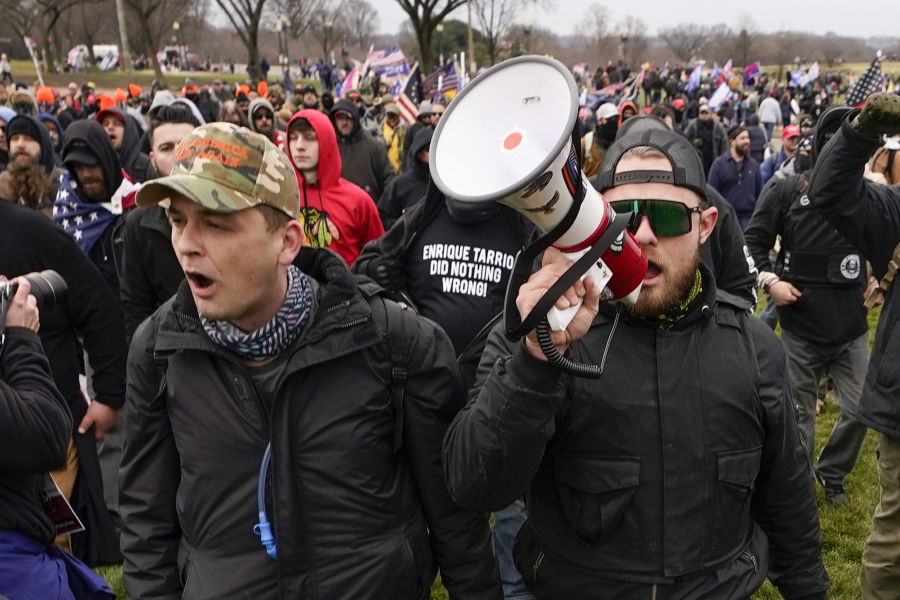 FILE - Proud Boys members Zachary Rehl, left, and Ethan Nordean, left, walk toward the U.S. Capitol in Washington, in support of President Donald Trump, Jan. 6, 2021. An upcoming hearing of the U.S. House Committee probing the Jan. 6 insurrection is expected to examine ties between people in former President Donald Trump's orbit and extremist groups who played a role in the Capitol riot.