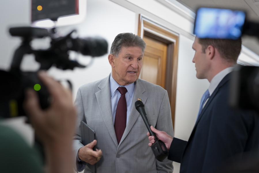 FILE - Sen. Joe Manchin, D-W.Va., talks to reporters at the Capitol in Washington, June 14, 2022. Manchin is roiling budget talks with Democratic leaders anew. The West Virginia Democrat says the latest inflation surge makes him more cautious about agreeing to federal spending increases that could drive consumers' costs even higher. (AP Photo/J.