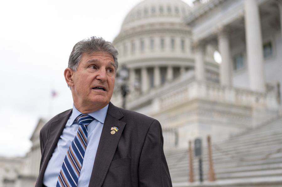 FILE - Sen. Joe Manchin, D-W.Va., departs as the Senate breaks for the Memorial Day recess, at the Capitol in Washington, May 26, 2022. A Democratic economic package focused on climate and health care faces hurdles but seems headed toward party-line passage by Congress next month.  Senate Majority Leader Chuck Schumer, D-N.Y., crafted a compromise package with Manchin, to the surprise of everyone, transforming the West Virginian from pariah to partner. (AP Photo/J.