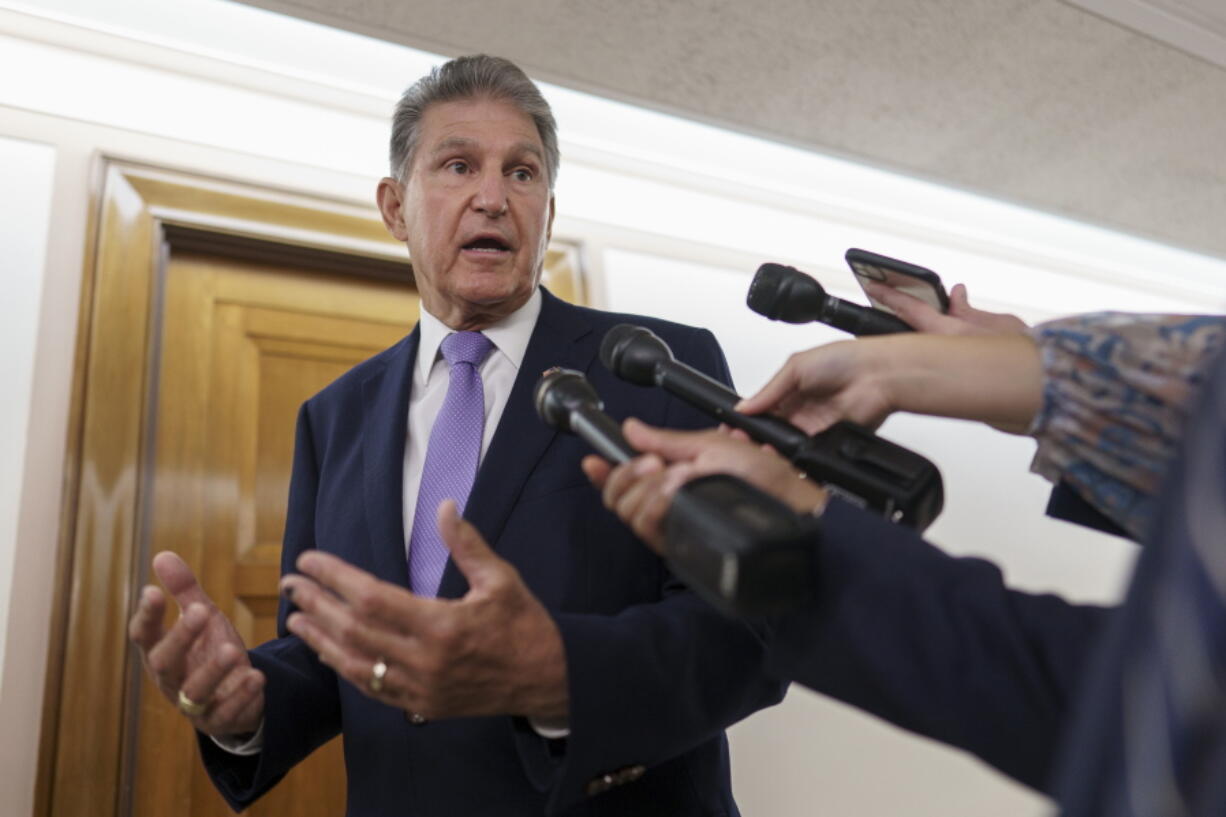 FILE - Sen. Joe Manchin, D-W.Va., talks with reporters on Capitol Hill in Washington, July 21, 2022. Senate Majority Leader Chuck Schumer and Manchin secreted themselves in a basement room at the Capitol. The two men had been wrestling for more than a year in long, failed rounds of start-and-stop negotiations over President Joe Biden's big rebuilding America package. But talks had jammed up -- again. With the midterm elections near, control of Congress at stake, the president and his party were at the end of the line. (AP Photo/J.