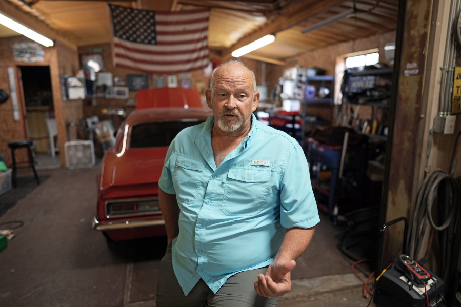 Retired Houston Fire Captain Russell Harris poses for a photograph inside his workshop at his home Wednesday, June 22, 2022, in East Bernard, Texas. (AP Photo/David J.