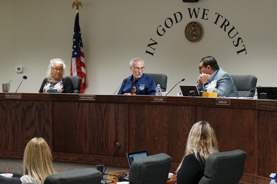 From left, Nye County Commissioners Debra Strickland, Frank Carbone and Leo Blundo discuss appointing a new county clerk on July 19, 2022 in Pahrump, Nev. The resignation of a county elections clerk in a rural county in Nevada has opened a window into the long-term consequences of election conspiracy theories.