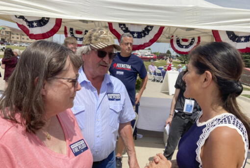 Former United Nations Ambassador Nikki Haley talks with Bob and Kathy de Koning, a farming couple from Sioux County, Iowa, Thursday, June 30, 2022, after headlining a fundraiser in northwest Iowa for Republican Rep. Randy Feenstra.