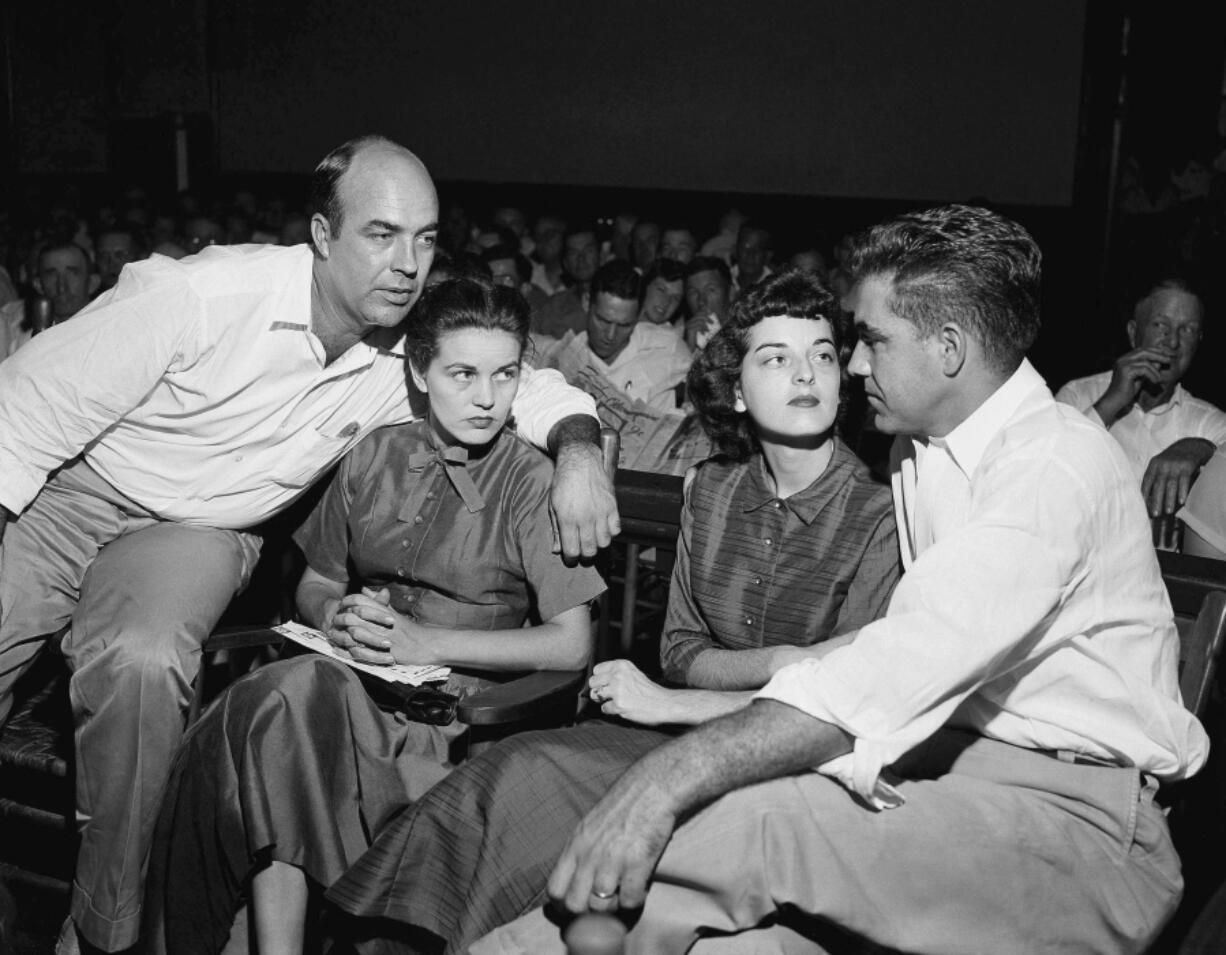 FILE - In this Sept. 23, 1955, file photo, J.W. Milam, left, his wife, second from left, Roy Bryant, far right, and his wife, Carolyn Bryant, sit together in a courtroom in Sumner, Miss. Bryant and his half-brother Milam were charged with murder but acquitted in the kidnapping and torture slaying of 14-year-old black teen Emmett Till in 1955 after he allegedly whistled at Carolyn Bryant. A team searching the basement of a Mississippi courthouse for evidence about the lynching of Black teenager Emmett Till has found the unserved warrant in June 2022 charging a white woman in his kidnapping in 1955, and relatives of the victim want authorities to finally arrest her nearly 70 years later.