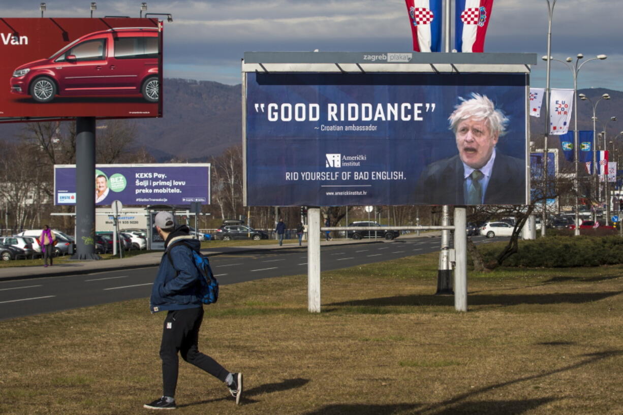 FILE - An advertising billboard for an English language school depicts Britain's prime minister Boris Johnson, in Zagreb, Croatia, Feb. 6, 2020. Outgoing U.K. Prime Minister Boris Johnson has been the bane of Brussels for many years, from his days stoking anti-European Union sentiment with exaggerated newspaper stories to his populist campaign leading Britain out of the bloc and reneging on the post-Brexit trade deal he himself signed.