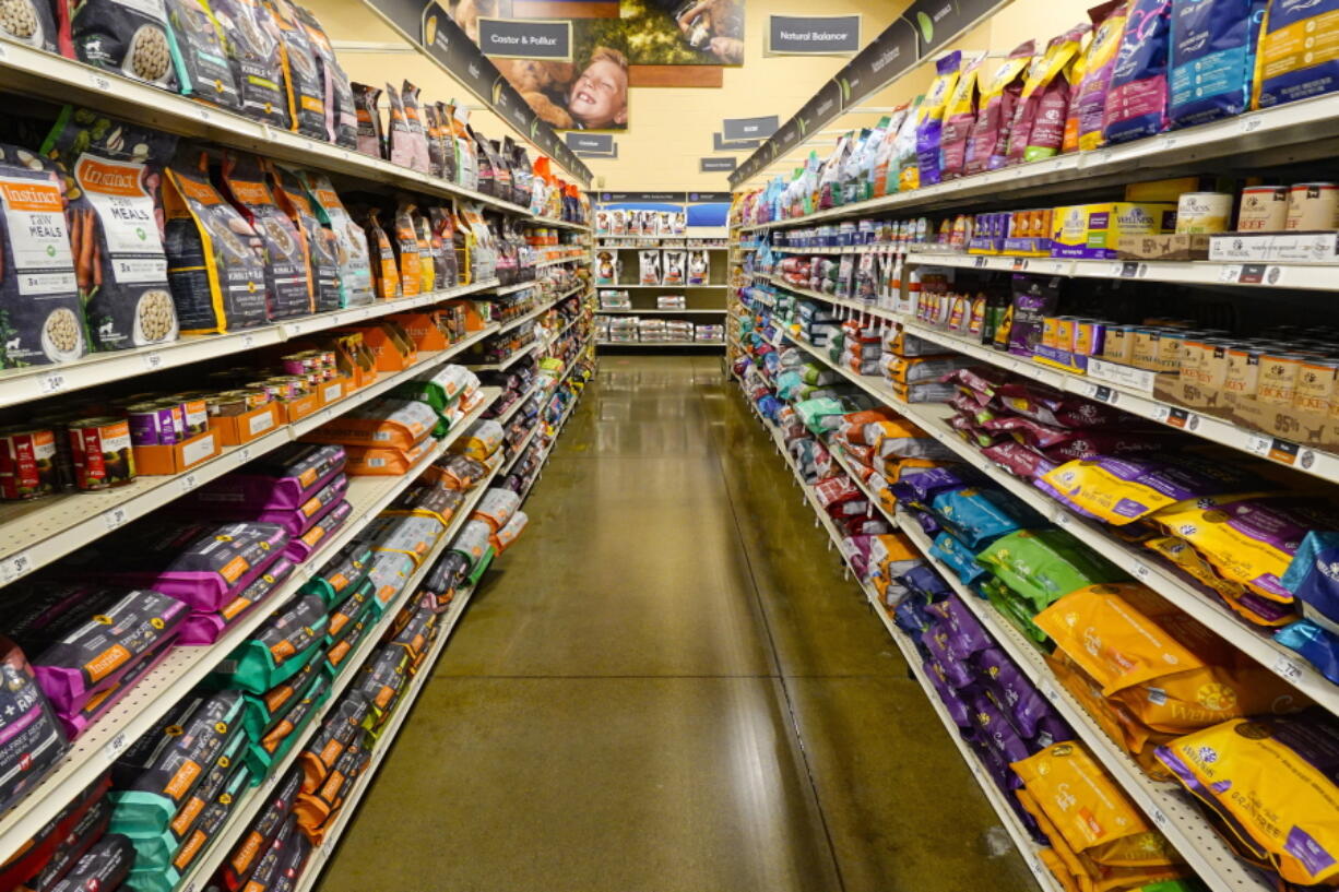 Dog food is shown in a pet store in Westfield, Ind., Tuesday, July 19, 2022. In 2018, the FDA began investigating whether the increasing popularity of grain-free dog foods had led to a sudden rise in a potentially fatal heart disease in dogs. Four years later, the FDA has reached no conclusion, but the publicity surrounding the issue has shrunk the once-promising market for grain-free dog foods.