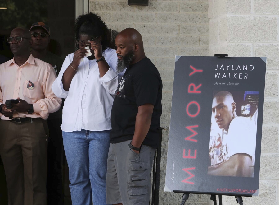 Family members of Jayland Walker stand behind the podium during a news conference as attorney Bobby DiCello, whose legal team is representing the family, speaks at St. Ashworth Temple Church of God in Christ, Monday, July 11, 2022, in Akron, Ohio.