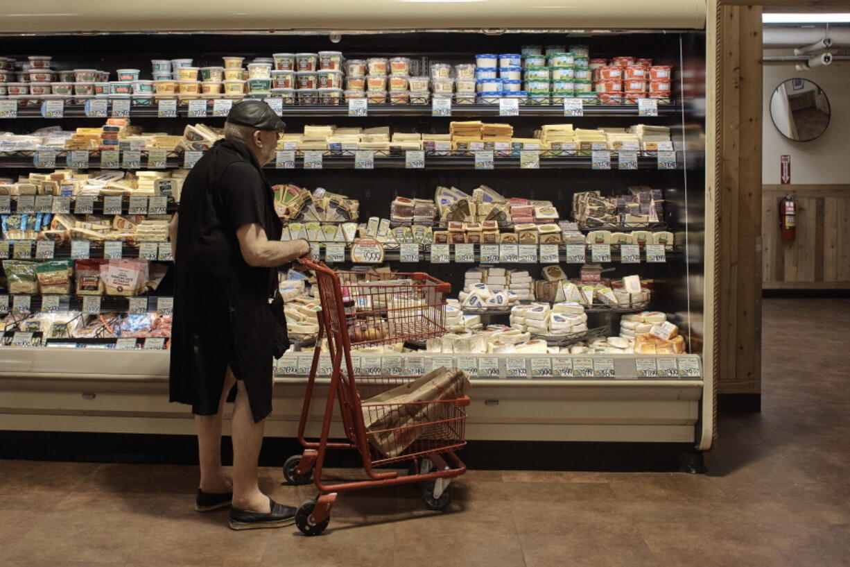 A man shops at a supermarket on Wednesday, July 27, 2022, in New York.  An inflation gauge that is closely tracked by the Federal Reserve, Friday, July 29,  jumped 6.8% in June from a year ago, the biggest increase in four decades, and leaving Americans with no relief from surging costs.