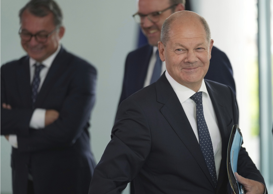 German Chancellor Olaf Scholz, front, arrives for the 'Concerted Action', a meeting of representatives of the German unions and the German employers with the German government at the Chancellery in Berlin, Germany, Monday, July 4, 2022.