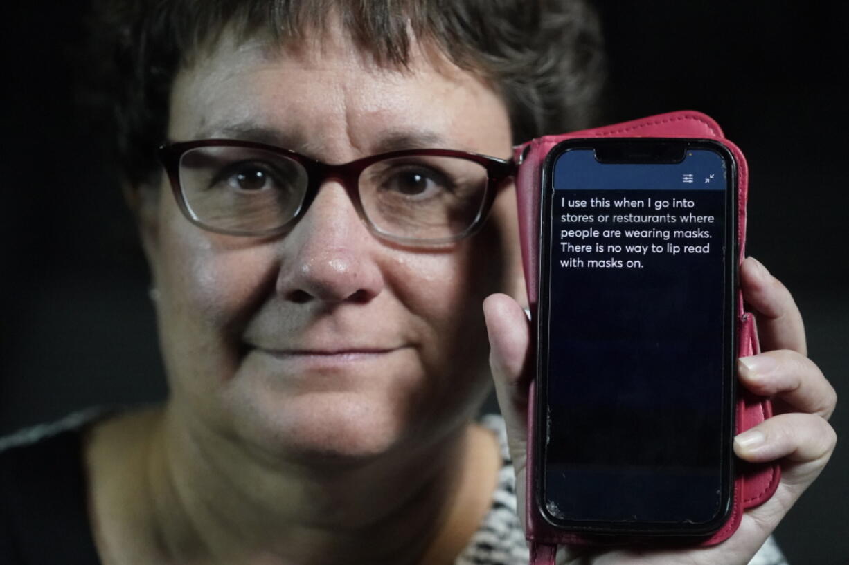 Chelle Wyatt uses her cell phone with the Otter app Friday, April 15, 2022, in Salt Lake City. People with hearing loss have adopted technology to navigate the world, especially as hearing aids are expensive and inaccessible to many.