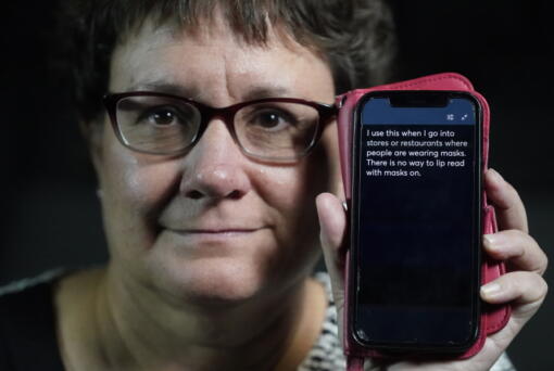 Chelle Wyatt uses her cell phone with the Otter app Friday, April 15, 2022, in Salt Lake City. People with hearing loss have adopted technology to navigate the world, especially as hearing aids are expensive and inaccessible to many.