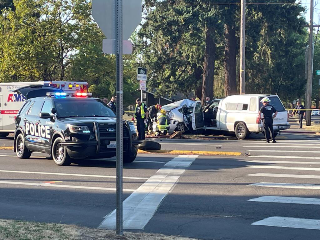 Emergency responders work at the scene of a fatal collision at Andresen Road and MacArthur Boulevard Wednesday evening. The driver of a Toyota was killed and the driver of a pickup truck was arrested.