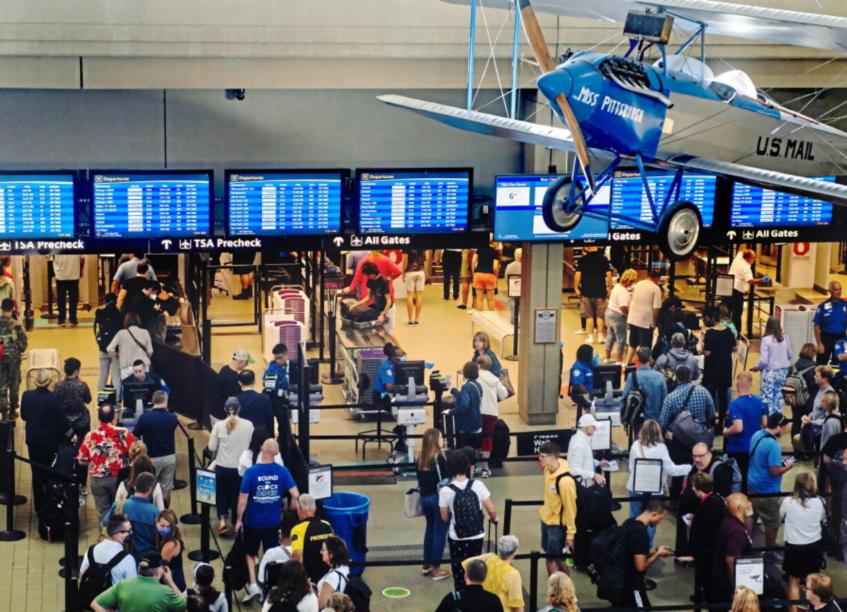 Passengers make their way through a security line Thursday, June 30, 2022, at the Pittsburgh International Airport in Moon Township, Pa. The airport saw an influx of travelers departing Pittsburgh before the Fourth of July holiday weekend.